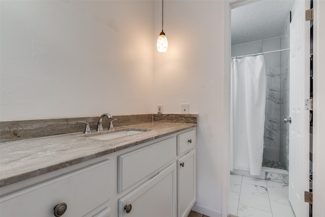 bathroom with vanity, walk in shower, a textured ceiling, and tile patterned flooring