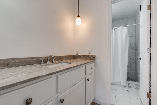 bathroom featuring vanity, a textured ceiling, and walk in shower