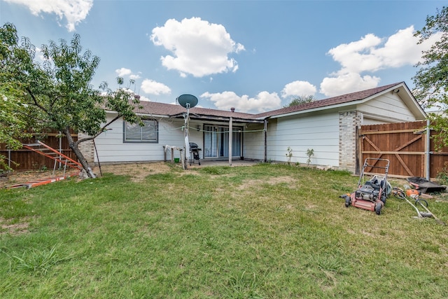 back of house with a yard