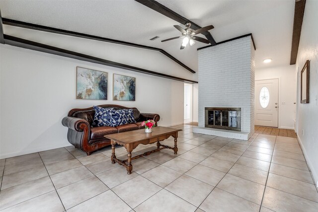 tiled living room with a textured ceiling, ceiling fan, brick wall, a fireplace, and lofted ceiling with beams