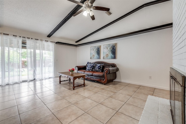 living room with light tile patterned floors, a textured ceiling, lofted ceiling with beams, and a brick fireplace