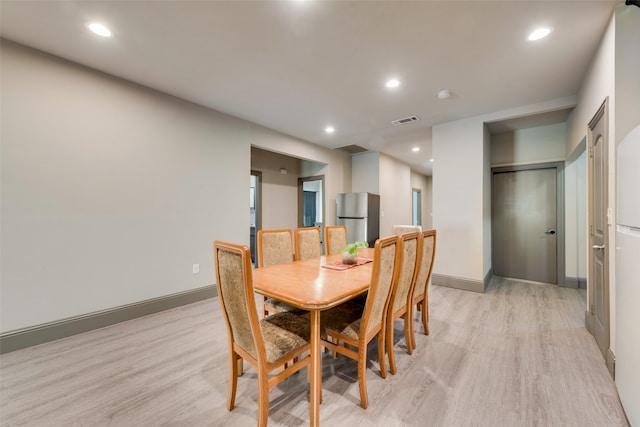 dining space with light hardwood / wood-style floors