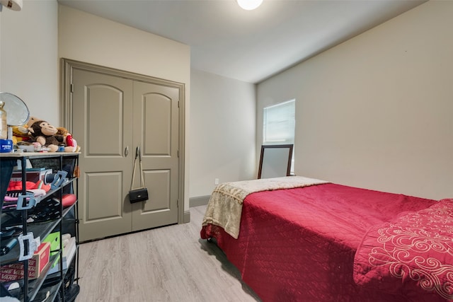 bedroom featuring hardwood / wood-style flooring and a closet