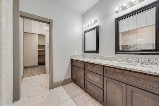 bathroom featuring tile patterned floors and dual bowl vanity