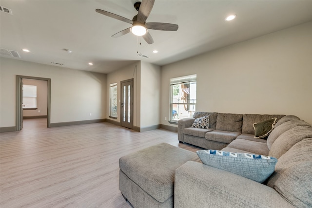 living room featuring light wood-type flooring and ceiling fan