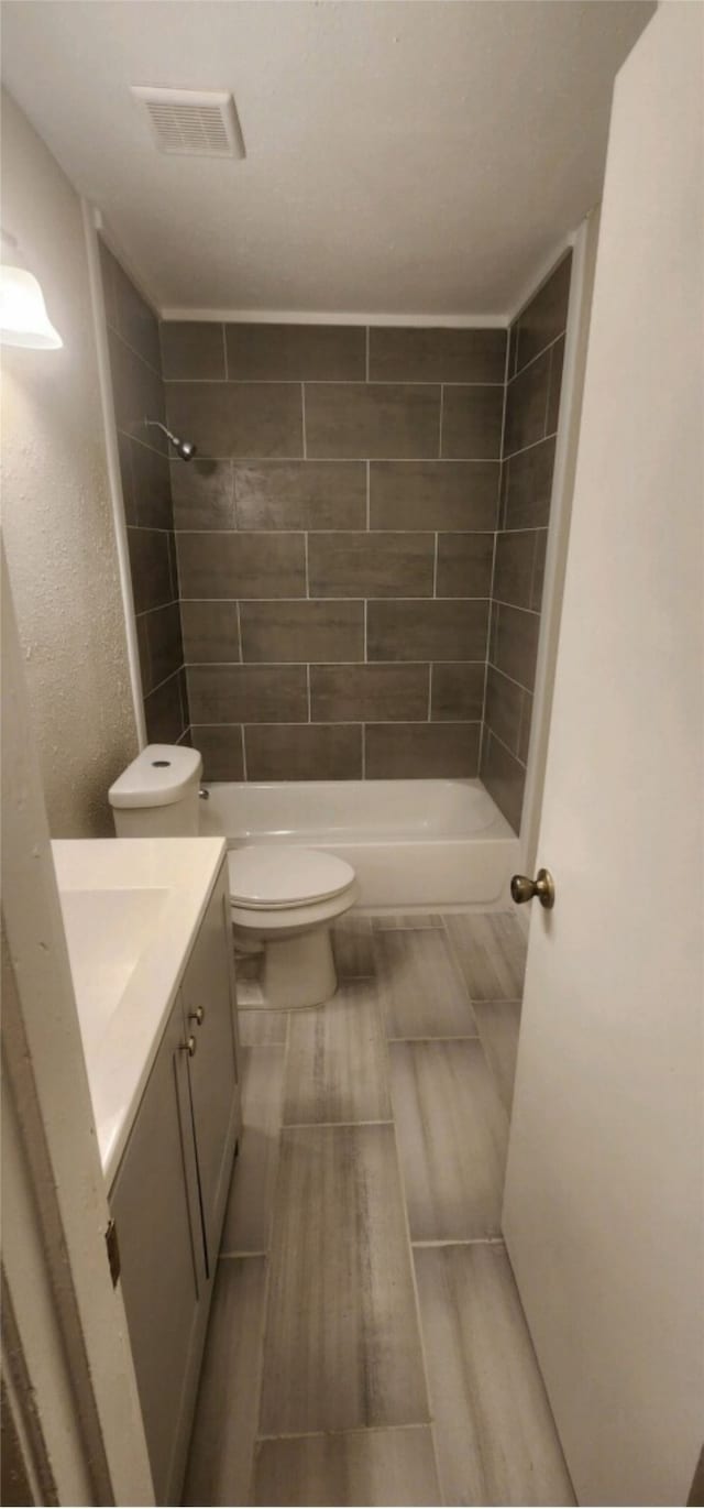 bathroom with tile patterned flooring, toilet, and vanity