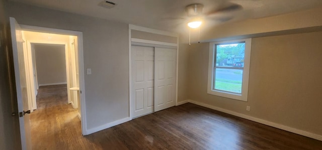 unfurnished bedroom with multiple windows, ceiling fan, hardwood / wood-style floors, and a closet