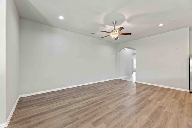 empty room featuring ceiling fan and hardwood / wood-style floors