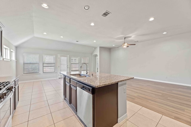 kitchen featuring stainless steel appliances, vaulted ceiling, sink, light tile patterned floors, and ceiling fan