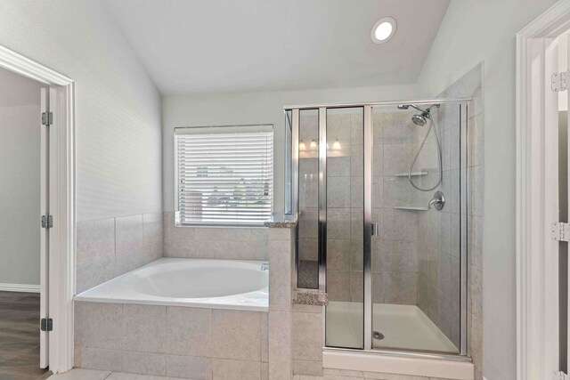 bathroom with wood-type flooring and plus walk in shower