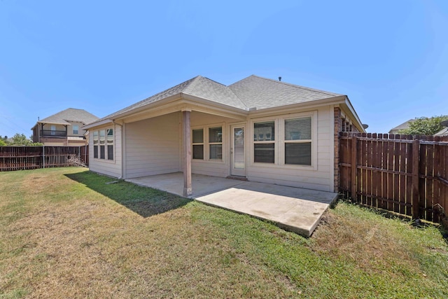 back of property featuring a yard and a patio