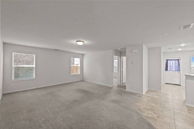 unfurnished room with light colored carpet