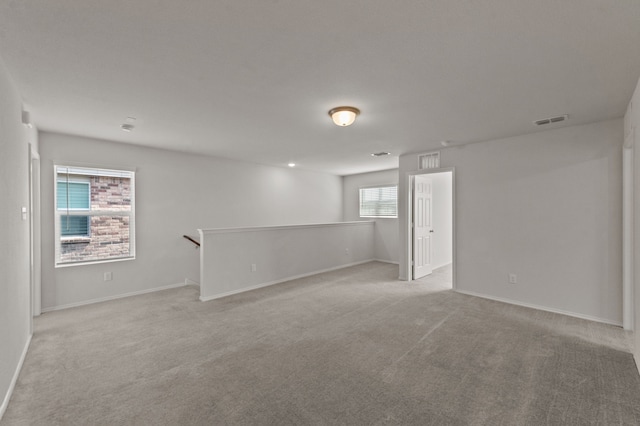 unfurnished room featuring light colored carpet