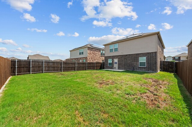 rear view of house with a yard