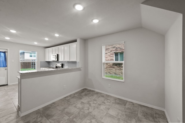 kitchen with white cabinetry, electric stove, kitchen peninsula, decorative backsplash, and light tile patterned floors