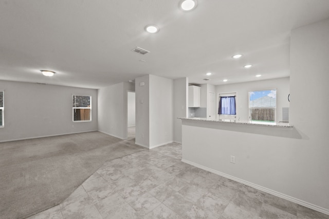 interior space featuring light colored carpet