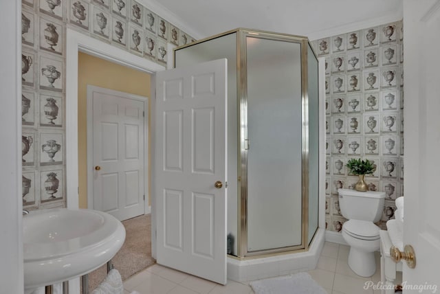 bathroom with a shower with shower door, ornamental molding, tile patterned flooring, and toilet