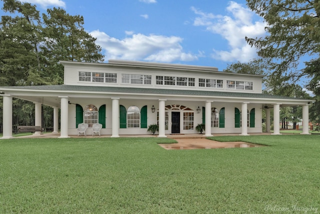 back of house with a lawn and covered porch