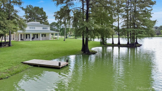 dock area with a yard and a water view