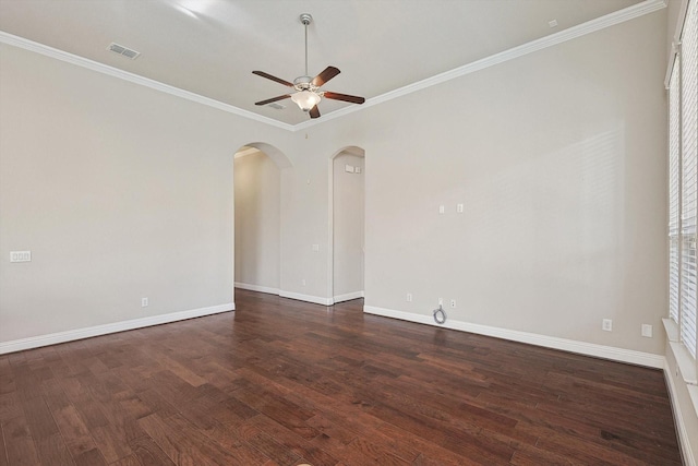 empty room featuring ceiling fan, dark hardwood / wood-style floors, and ornamental molding