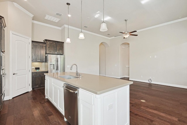 kitchen with appliances with stainless steel finishes, dark brown cabinets, a kitchen island with sink, sink, and white cabinets