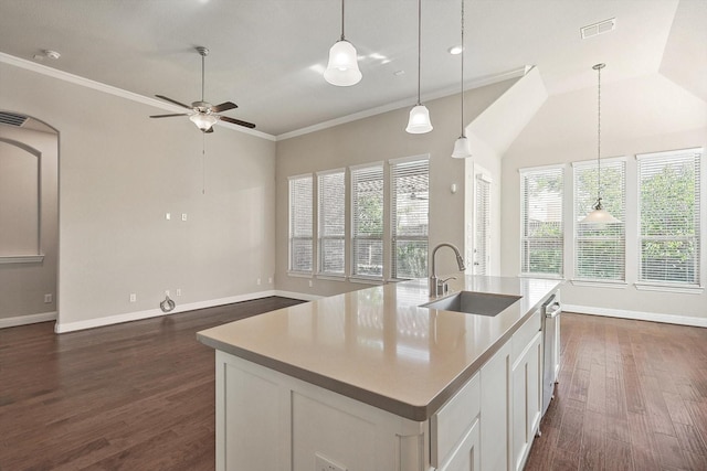 kitchen featuring ceiling fan, sink, pendant lighting, a kitchen island with sink, and white cabinets