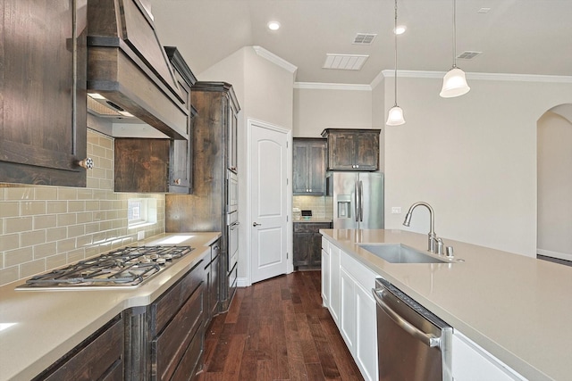 kitchen featuring backsplash, sink, pendant lighting, and appliances with stainless steel finishes