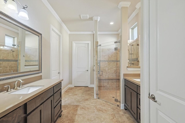 bathroom featuring vanity, ornamental molding, walk in shower, and a wealth of natural light