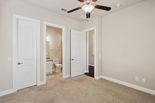 unfurnished bedroom featuring light colored carpet, ceiling fan, and ensuite bathroom