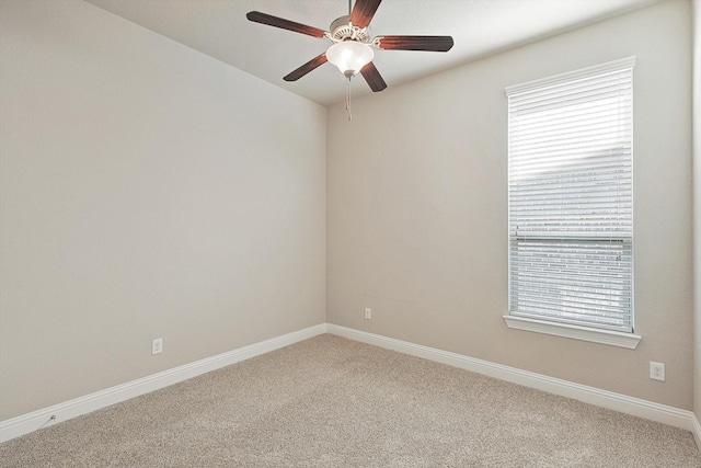 unfurnished room featuring ceiling fan, carpet, and a healthy amount of sunlight