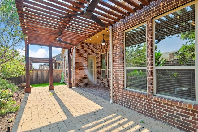 view of patio / terrace with ceiling fan and a pergola