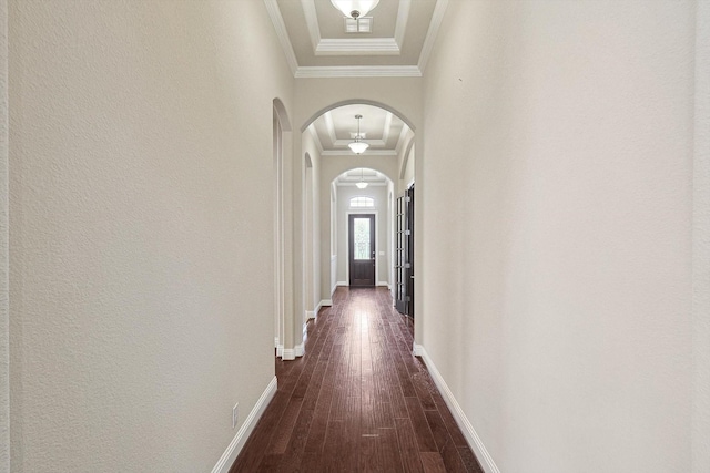 hall with dark wood-type flooring and ornamental molding