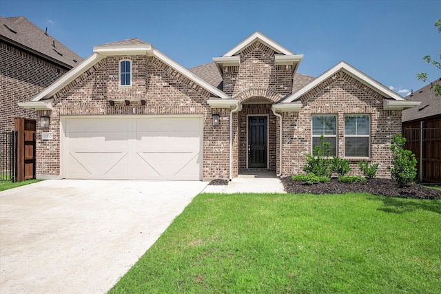 view of front of house featuring a garage and a front lawn