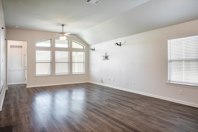 spare room featuring dark hardwood / wood-style floors, lofted ceiling, and ceiling fan