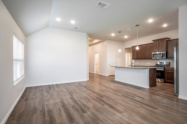 kitchen featuring hanging light fixtures, dark hardwood / wood-style flooring, an island with sink, and stainless steel appliances