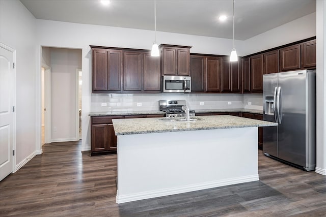 kitchen featuring appliances with stainless steel finishes, dark brown cabinets, decorative backsplash, and dark hardwood / wood-style floors