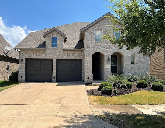 french provincial home featuring a garage