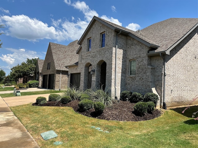 view of property exterior with a garage and a yard