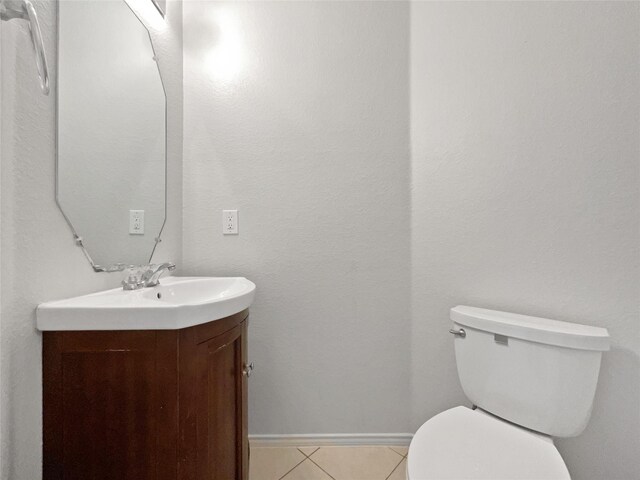 bathroom featuring vanity, tile patterned floors, and toilet