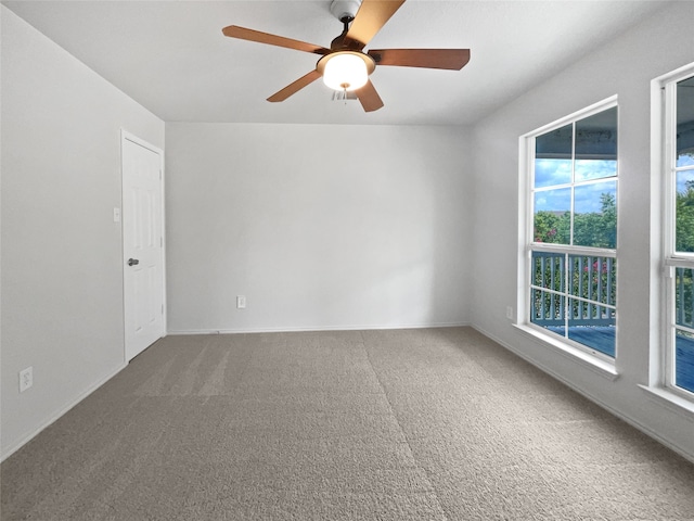 spare room with carpet and ceiling fan