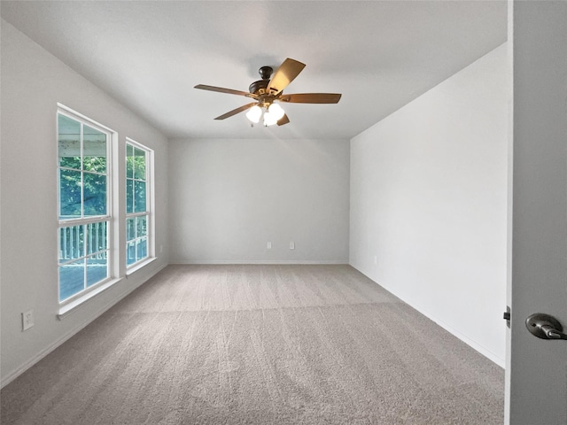 carpeted empty room featuring ceiling fan