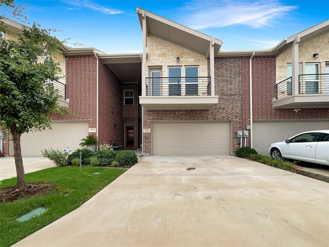 view of front of home featuring a garage and a balcony