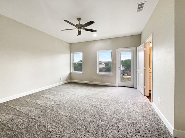 unfurnished room featuring carpet, plenty of natural light, and ceiling fan