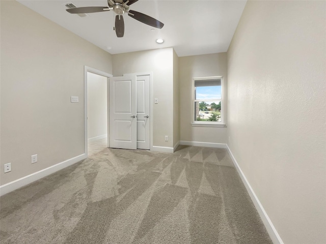 unfurnished bedroom with carpet floors and ceiling fan