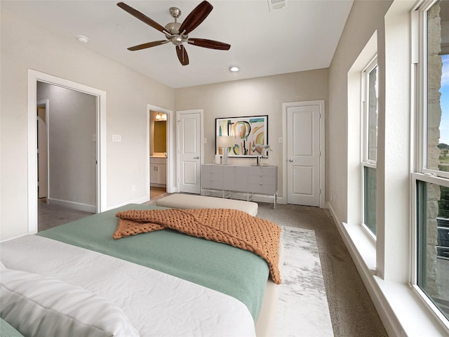 carpeted bedroom with ceiling fan and connected bathroom