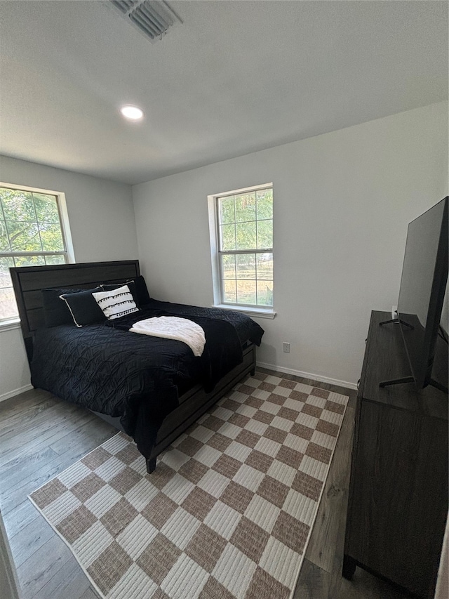 bedroom featuring light hardwood / wood-style floors and multiple windows