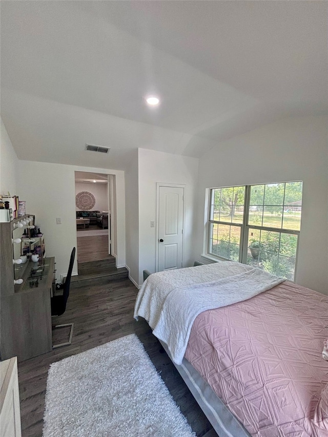 bedroom with lofted ceiling and dark hardwood / wood-style floors