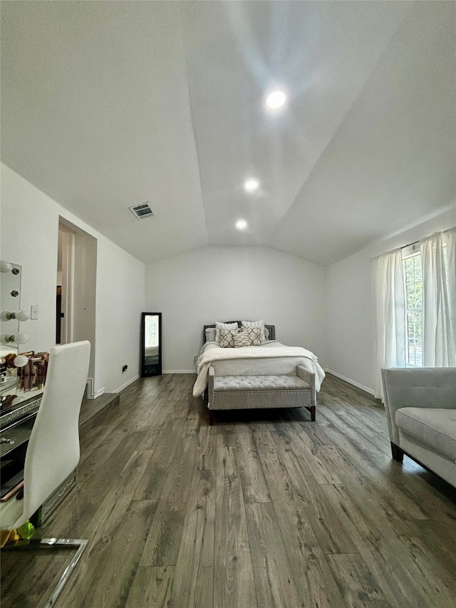 bedroom with lofted ceiling and dark hardwood / wood-style flooring