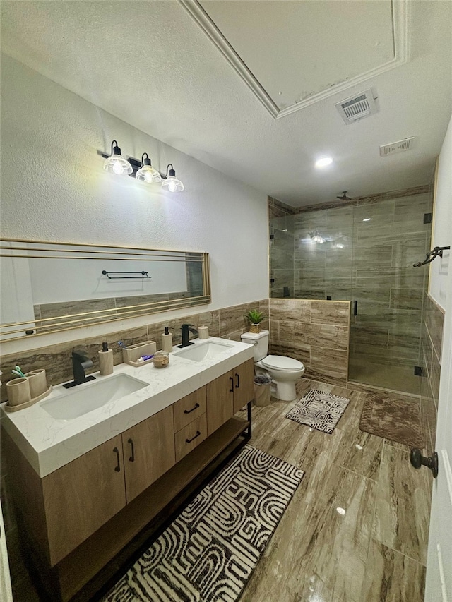 bathroom featuring toilet, walk in shower, tile walls, vanity, and hardwood / wood-style flooring