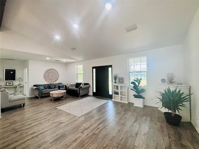 living room with hardwood / wood-style floors and vaulted ceiling